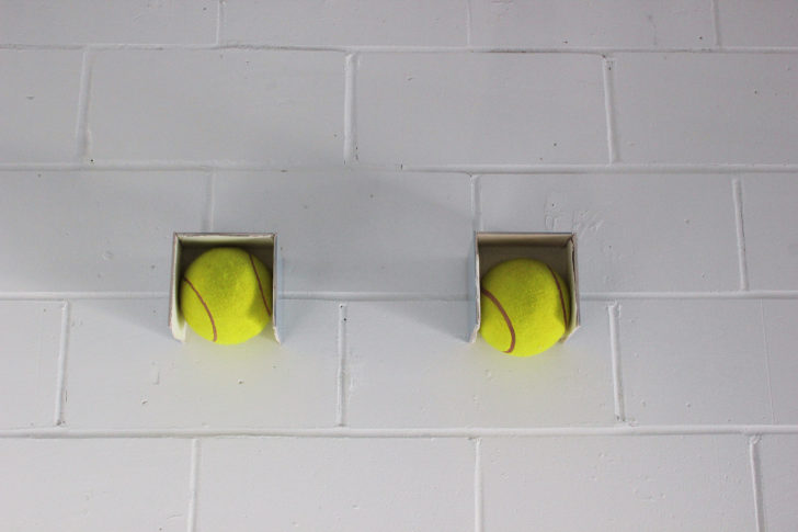 <i>Balls</i> 2010, Oversized tennis balls, tiles, silicon, 2010.  19 x 62 x 15 cm